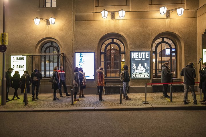 eine Gruppe von Menschen, die vor einem Gebäude gehen